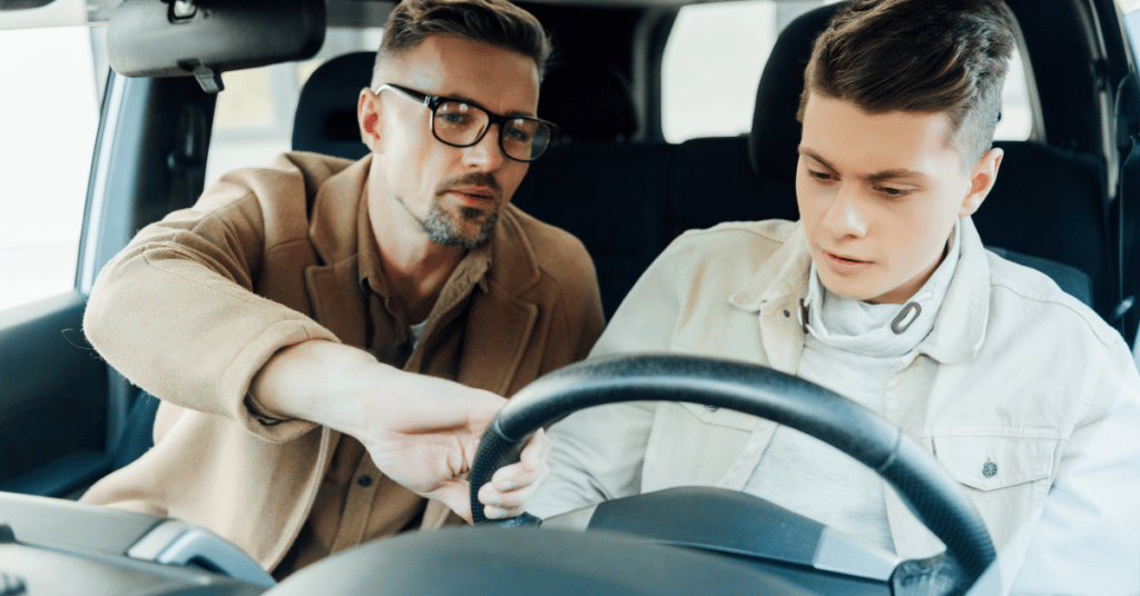 Young teen driver driving his with father