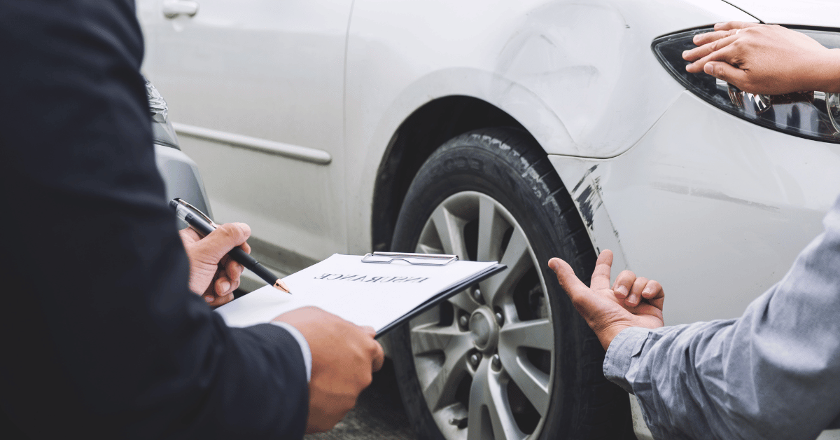 Insurance Agent examining car damages after the accident